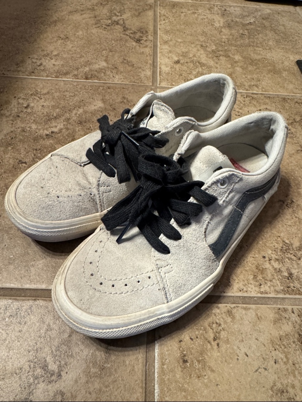White suede vans with charcoal accent and laces.